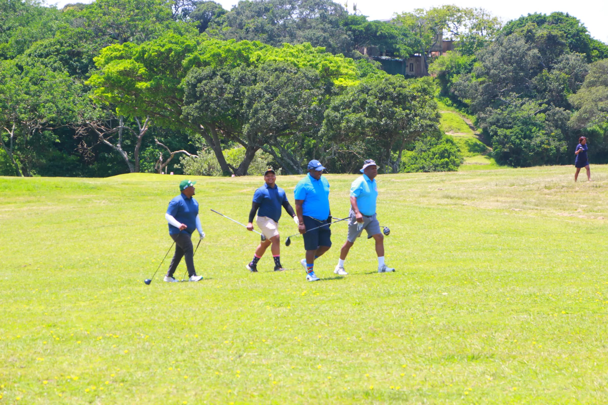 Four golfers walking the fairway on a club golf day